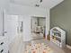A lovely bedroom view with light wood flooring and mirrored closet doors at 5019 Ne 125Th Loop, Oxford, FL 34484