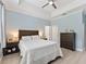 Well-lit bedroom with a tray ceiling, ceiling fan, and neutral tones, creating a relaxing retreat at 5019 Ne 125Th Loop, Oxford, FL 34484