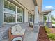 Cozy front porch featuring stone accents, cushioned seating, and manicured landscaping, perfect for relaxing outdoors at 5019 Ne 125Th Loop, Oxford, FL 34484