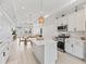 Open kitchen and dining area filled with stainless appliances and neutral colors at 5019 Ne 125Th Loop, Oxford, FL 34484
