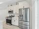 Kitchen with stainless steel appliances and white cabinetry at 5019 Ne 125Th Loop, Oxford, FL 34484