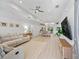 Spacious open-concept living room with bright lighting, hardwood floors, and comfortable seating at 5019 Ne 125Th Loop, Oxford, FL 34484