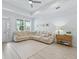 Bright and airy living room with a large window, plush sectional sofa, and modern decor at 5019 Ne 125Th Loop, Oxford, FL 34484