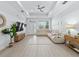 Spacious living area with a comfortable sectional, stylish decor, and ample natural light from large windows at 5019 Ne 125Th Loop, Oxford, FL 34484