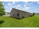 Well-maintained backyard showcasing the home's exterior and landscaping at 5068 Ne 121St Ave, Oxford, FL 34484