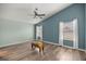 Bright bedroom with a ceiling fan, and wood-look flooring at 5068 Ne 121St Ave, Oxford, FL 34484