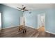 Spacious bedroom features a ceiling fan, ensuite bathroom, and wood-look floors at 5068 Ne 121St Ave, Oxford, FL 34484