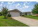 Charming single-story home with well-maintained lawn and an attached two-car garage at 5068 Ne 121St Ave, Oxford, FL 34484