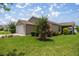 Charming single-story home with a well-manicured lawn and flowering shrubbery at 5068 Ne 121St Ave, Oxford, FL 34484