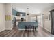 Modern kitchen with stainless steel appliances and a breakfast bar with seating at 5068 Ne 121St Ave, Oxford, FL 34484
