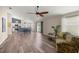 Spacious living room with hardwood floors and stylish furniture, flowing into the kitchen at 5068 Ne 121St Ave, Oxford, FL 34484