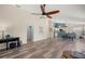 Open-concept living room with hardwood floors, leading into the kitchen and dining area at 5068 Ne 121St Ave, Oxford, FL 34484