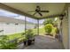 Relaxing screened-in patio with a ceiling fan and view of the landscaped backyard at 5068 Ne 121St Ave, Oxford, FL 34484