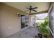 Relaxing screened-in patio featuring ceiling fan and sliding glass doors to the house at 5068 Ne 121St Ave, Oxford, FL 34484