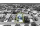 Monochrome aerial photo with brightened highlighted property gives an overview of the lot and neighborhood at 5964 Brittania Blvd, Tavares, FL 32778