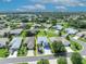 Aerial view showcases the property and neighborhood with lush green lawns and mature trees surrounding each single-Gathering home at 5964 Brittania Blvd, Tavares, FL 32778