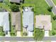 Aerial view shows a well-maintained home with mature trees, landscaped yard, and neighboring properties at 5964 Brittania Blvd, Tavares, FL 32778