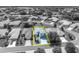 Black and white aerial view showcasing the neighborhood, highlighting the property with a yellow outline at 5964 Brittania Blvd, Tavares, FL 32778