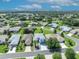 Aerial view showcases the property and neighborhood with lush green lawns and mature trees surrounding each single-Gathering home at 5964 Brittania Blvd, Tavares, FL 32778