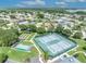 Aerial view showcasing community tennis and bocce courts surrounded by green spaces and single Gathering homes at 5964 Brittania Blvd, Tavares, FL 32778