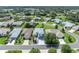 An aerial view of a well-maintained neighborhood with lush green lawns and mature trees surrounding each single-Gathering home at 5964 Brittania Blvd, Tavares, FL 32778