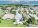 Aerial view of a backyard featuring a fire pit with landscaping, and a peaceful neighborhood at 5964 Brittania Blvd, Tavares, FL 32778