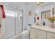 Bright bathroom featuring a glass enclosed shower, white cabinets, and a neutral color palette at 5964 Brittania Blvd, Tavares, FL 32778