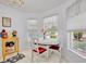 Bright breakfast nook featuring tile floors, a chandelier and a view of the community at 5964 Brittania Blvd, Tavares, FL 32778