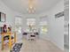 Bright breakfast nook featuring tile floors, a chandelier and a view of the community at 5964 Brittania Blvd, Tavares, FL 32778