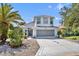 Charming two-story home with a well-manicured lawn, long driveway, and lovely landscaping at 5964 Brittania Blvd, Tavares, FL 32778