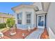 Close up of the charming blue front door with decorative features and landscaped surroundings at 5964 Brittania Blvd, Tavares, FL 32778
