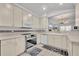 Well-equipped kitchen with stainless steel appliances, tile floor, and light colored cabinets at 5964 Brittania Blvd, Tavares, FL 32778
