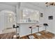 Kitchen pass-through to the entry featuring a breakfast bar and stainless steel bar stools at 5964 Brittania Blvd, Tavares, FL 32778