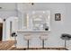Kitchen pass-through to the entry featuring a breakfast bar with modern bar stools at 5964 Brittania Blvd, Tavares, FL 32778