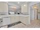 Kitchen featuring light cabinets and a convenient pass-through breakfast bar area at 5964 Brittania Blvd, Tavares, FL 32778