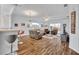 Bright living room with hardwood floors, bar seating, and comfortable furnishings at 5964 Brittania Blvd, Tavares, FL 32778