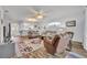 Cozy living room with wood floors, ceiling fan, and multiple seating options at 5964 Brittania Blvd, Tavares, FL 32778