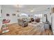 Bright living room with hardwood floors, bar seating, and comfortable furnishings at 5964 Brittania Blvd, Tavares, FL 32778
