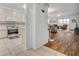 Open concept kitchen and living room featuring hardwood floors and an adjacent living area at 5964 Brittania Blvd, Tavares, FL 32778