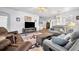 Comfortable living room with a fireplace, TV, and a stylish southwestern themed rug at 5964 Brittania Blvd, Tavares, FL 32778
