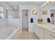 Main bathroom featuring a large soaking tub, double sinks, and walk-in shower at 5964 Brittania Blvd, Tavares, FL 32778