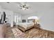 Main bedroom with wood-look floors, ceiling fan, and soft natural light at 5964 Brittania Blvd, Tavares, FL 32778