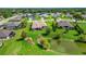 Expansive backyard featuring a pond and green space in a peaceful neighborhood setting at 6008 Apex Way, Lady Lake, FL 32159