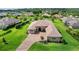 Desirable home features impeccable landscaping with mature trees, and a brick paved drive-way, providing picturesque curb appeal at 6008 Apex Way, Lady Lake, FL 32159