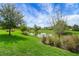 Landscaped backyard featuring a tranquil pond and lush greenery, offering a serene retreat at 6008 Apex Way, Lady Lake, FL 32159