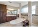 Bathroom featuring a soaking tub, shower with glass partition, and vanity at 6008 Apex Way, Lady Lake, FL 32159