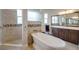 Bathroom with soaking tub, tile accents, and vanity with framed mirror at 6008 Apex Way, Lady Lake, FL 32159
