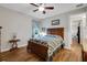 Serene bedroom with wood floors, a ceiling fan, and tranquil decor at 6008 Apex Way, Lady Lake, FL 32159