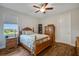 Cozy bedroom with wood floors, a ceiling fan, and plenty of closet space at 6008 Apex Way, Lady Lake, FL 32159