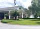 Charming clubhouse with manicured landscaping and fountain feature at 6008 Apex Way, Lady Lake, FL 32159